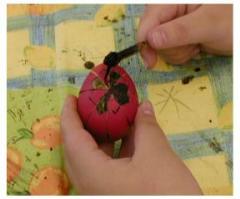 Pysanky: this egg has been dyed in various colours, most recently red.  Areas being covered in wax at this stage will remain red