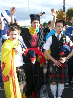 A Ukrainian supporter poses with some Scots